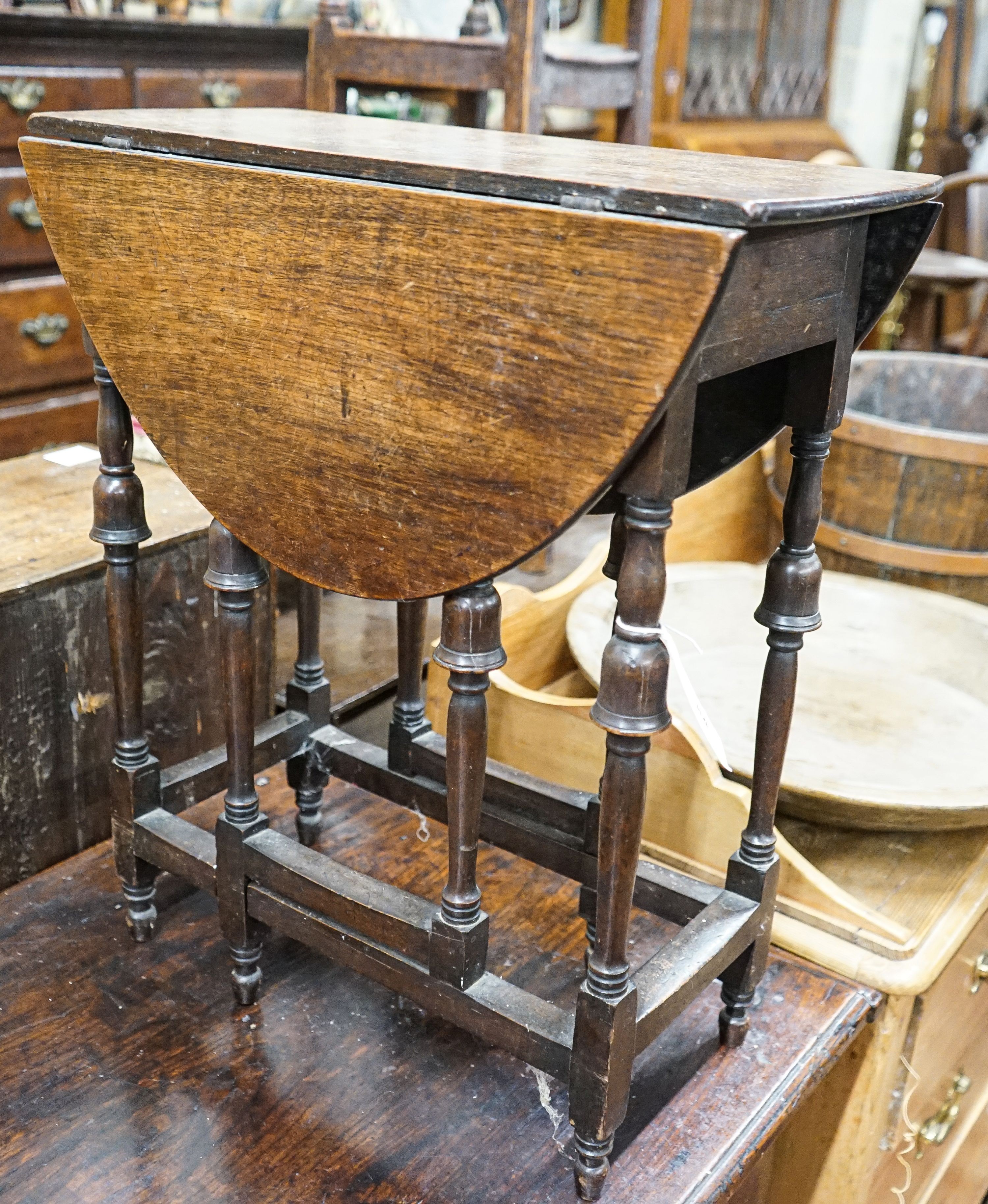 An unusually small late 17th century style mahogany gateleg table, with oval top and inverted cup turned legs, 65cm extended, depth 57cm, height 55cm